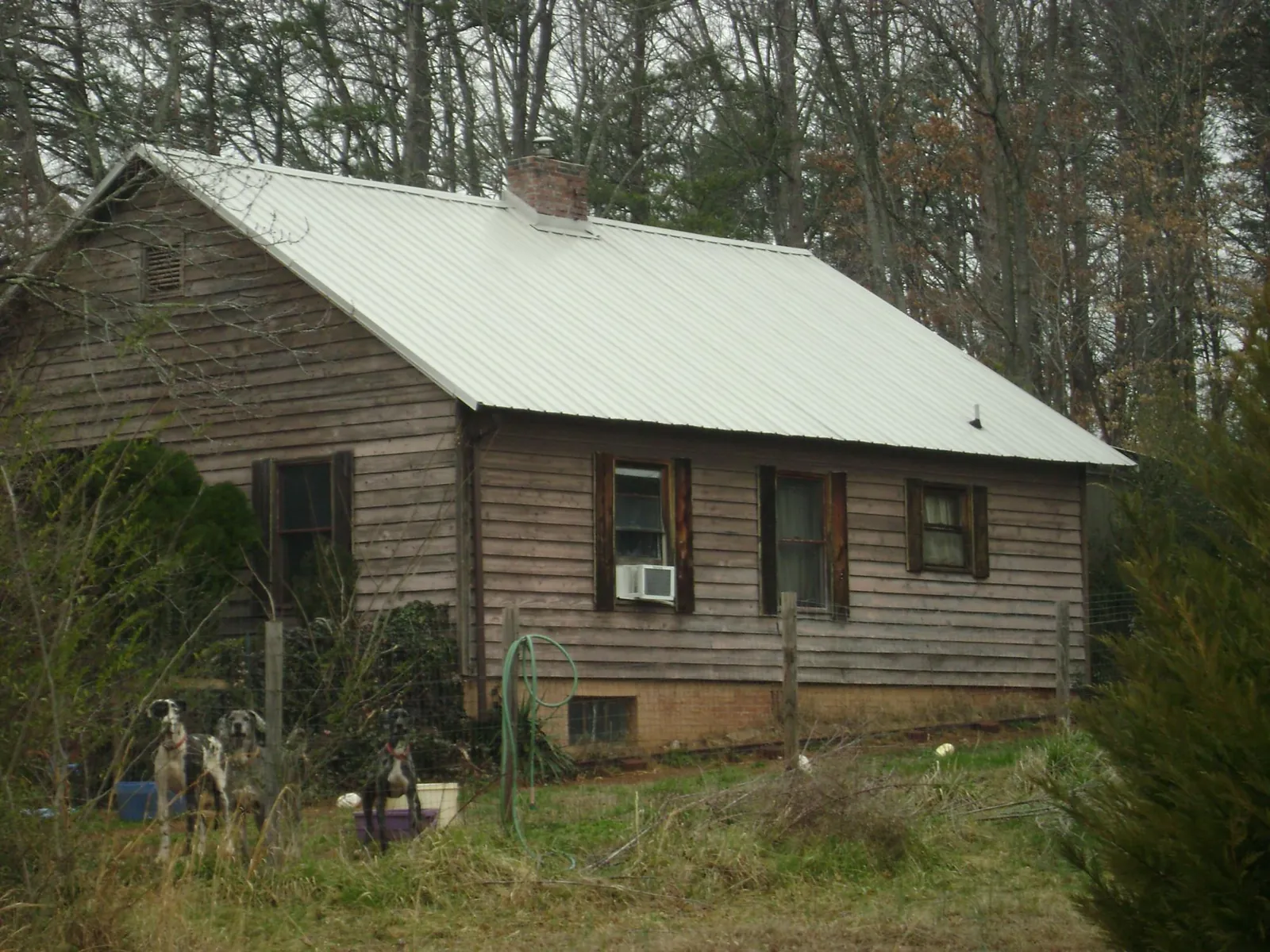 White metal roof on an old wood sided farmhouse, from a Metal Roof Installation job in Kootenai